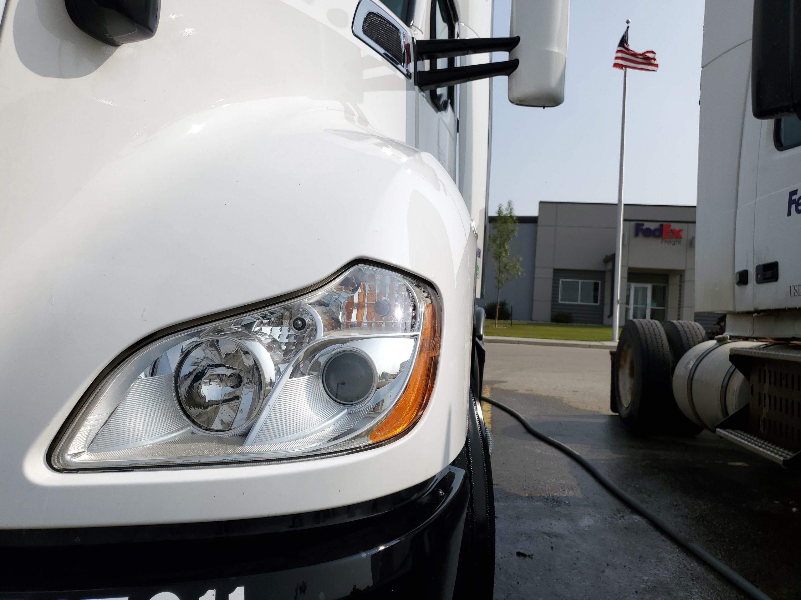 clean front left headlight view of semi cab